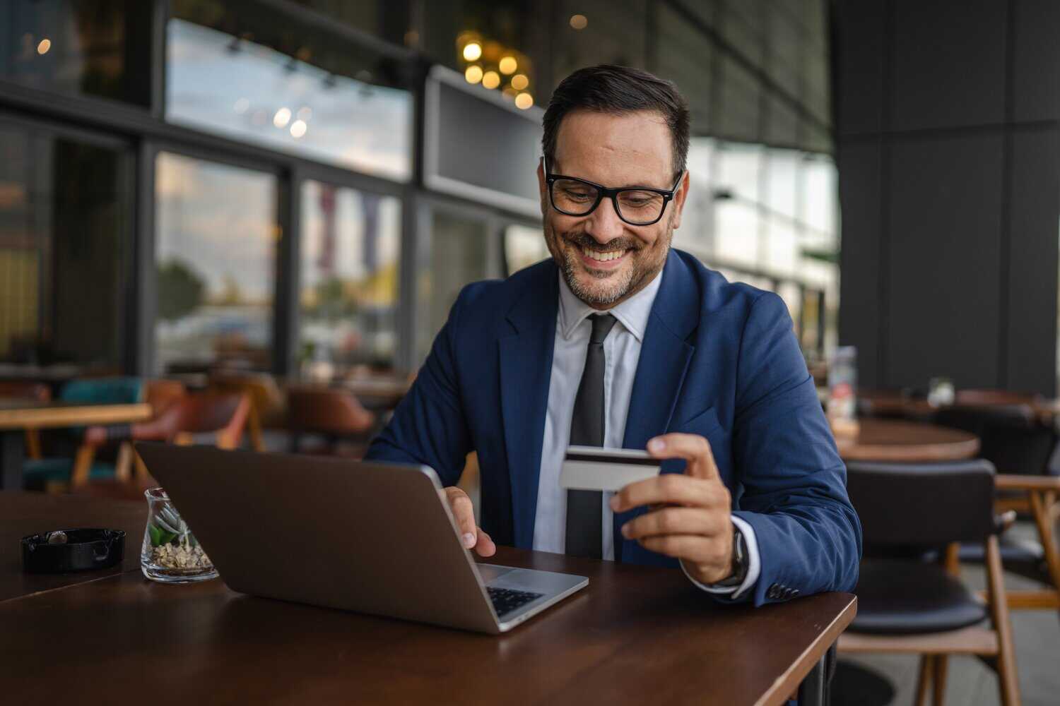 A businessman performs an online payment. Handling it is one of the functions of a payment platform.