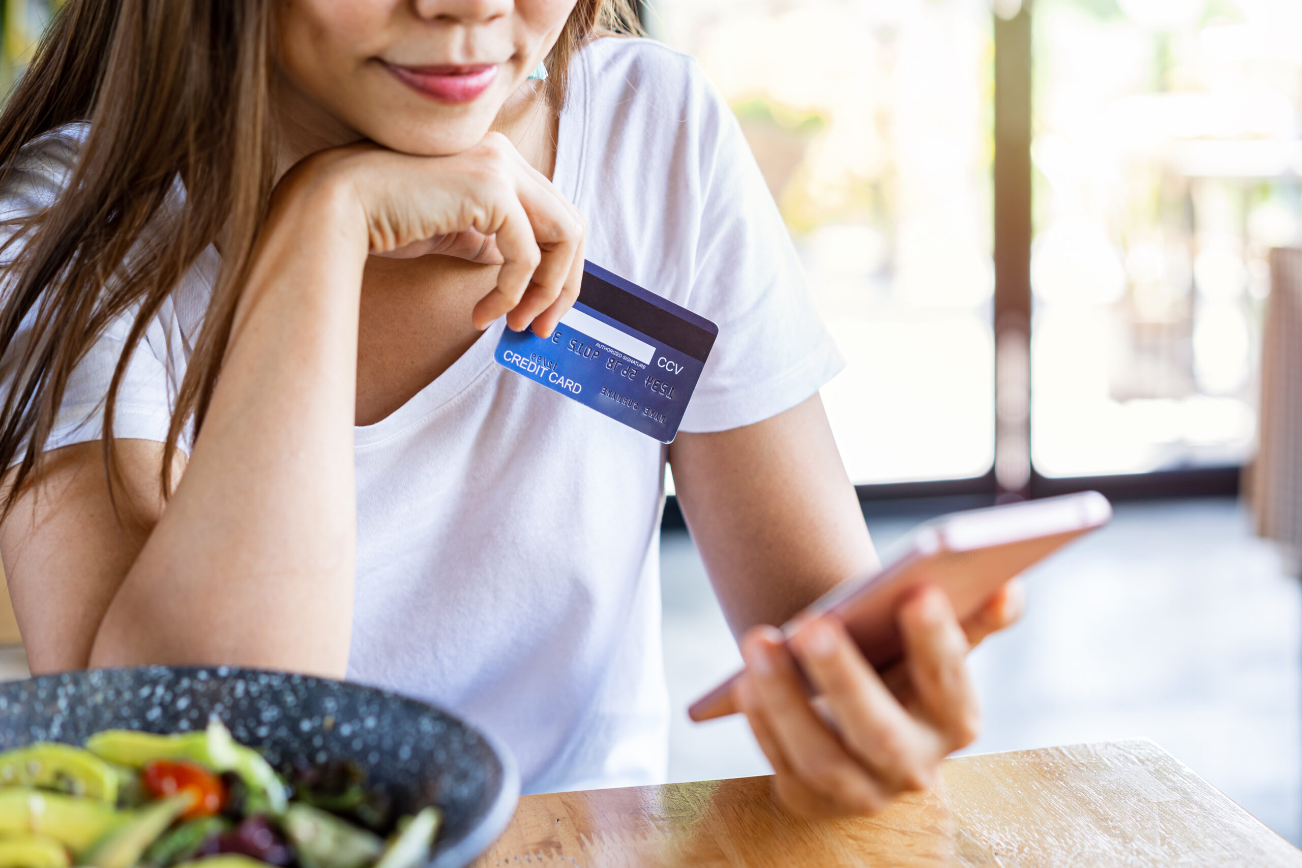 A woman prepares to pay for her food online. Fragmented payment setups can lose you business.
