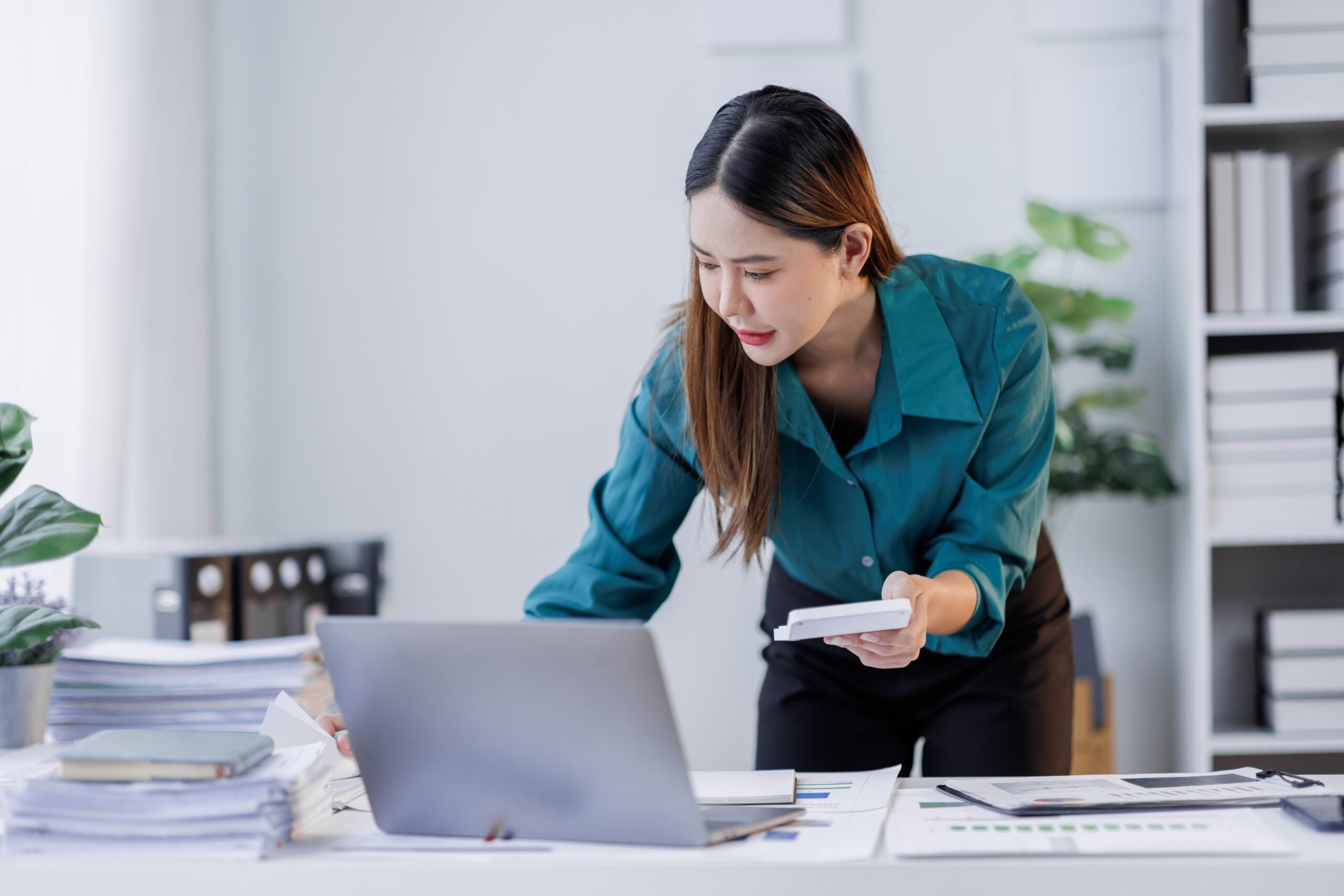 An accountant calculates monthly earnings. In business, settlement speed can affect your cash flow.