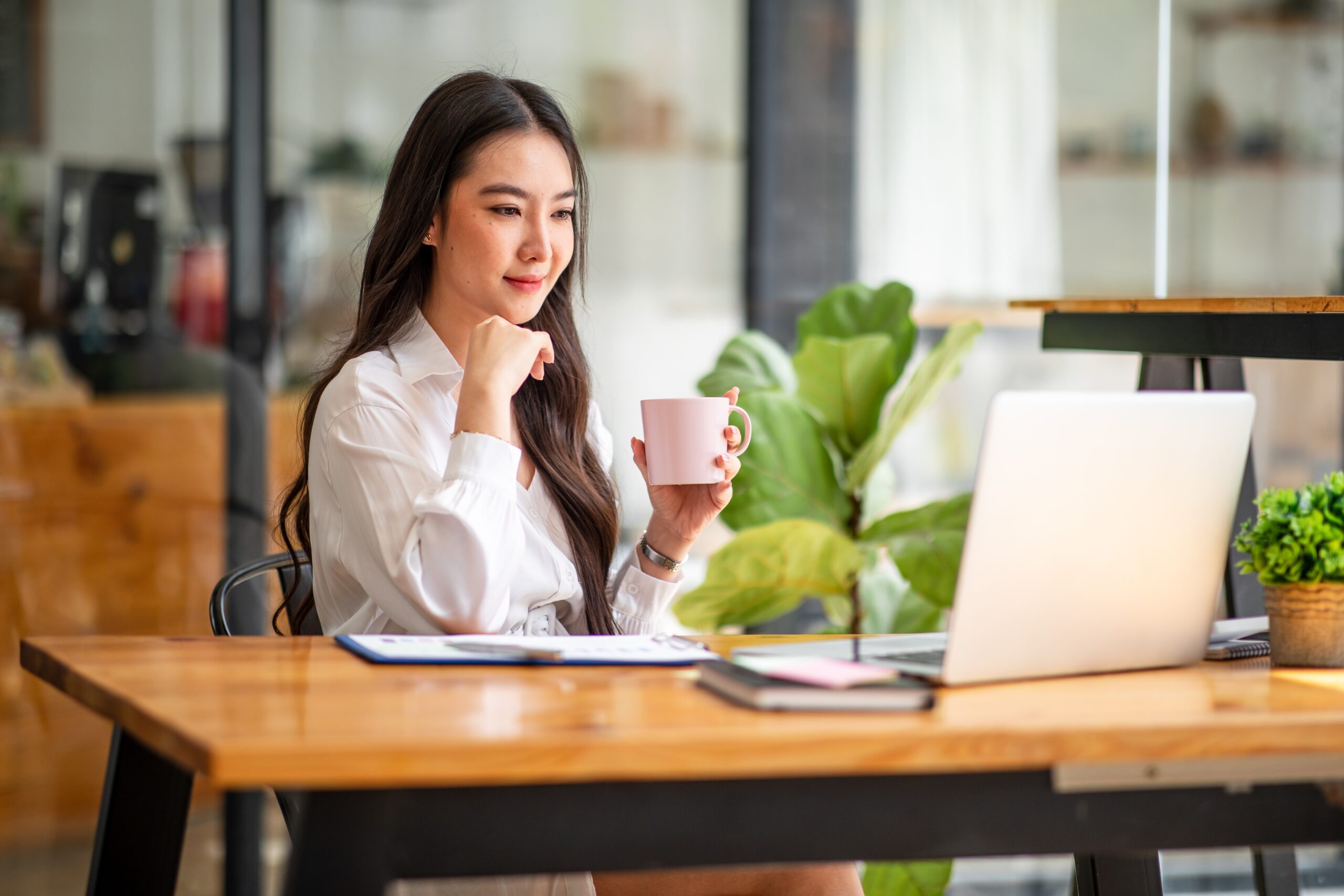 A businesswoman contemplates how to best approach digital invoicing for payments in Singapore.