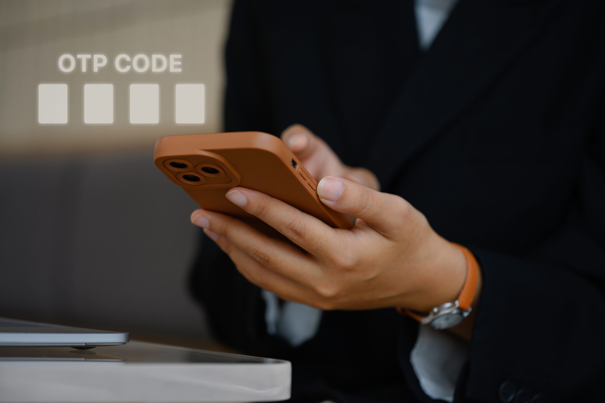 Person using a smartphone to enter an OTP code for secure payment authentication